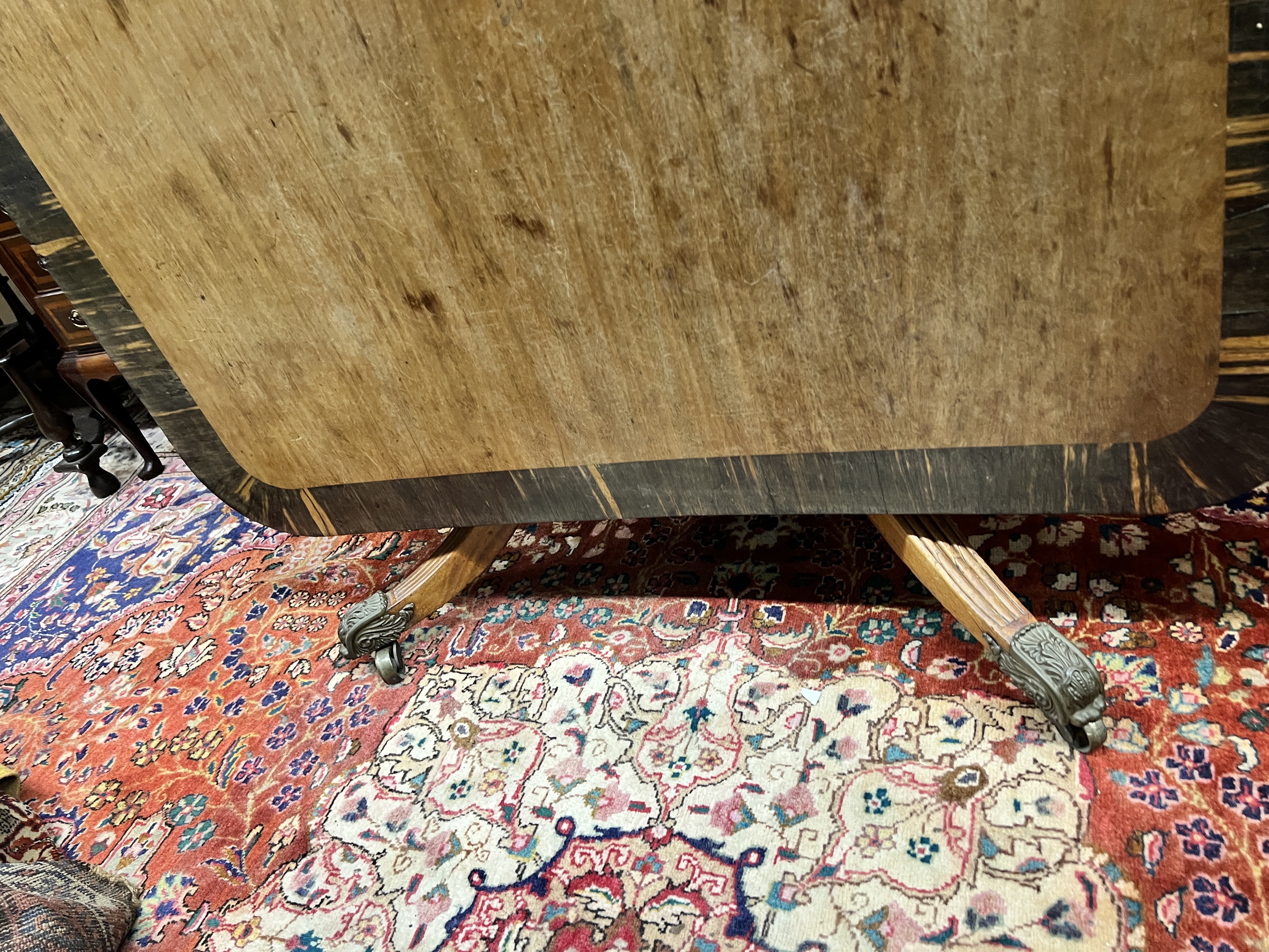 A Regency coromandel banded rectangular mahogany tilt top dining table, length 160cm, width 106cm, height 74cm